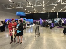 Students talking infront of booths in the Expo Hall