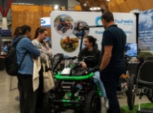 Students talking infront of booths in the Expo Hall