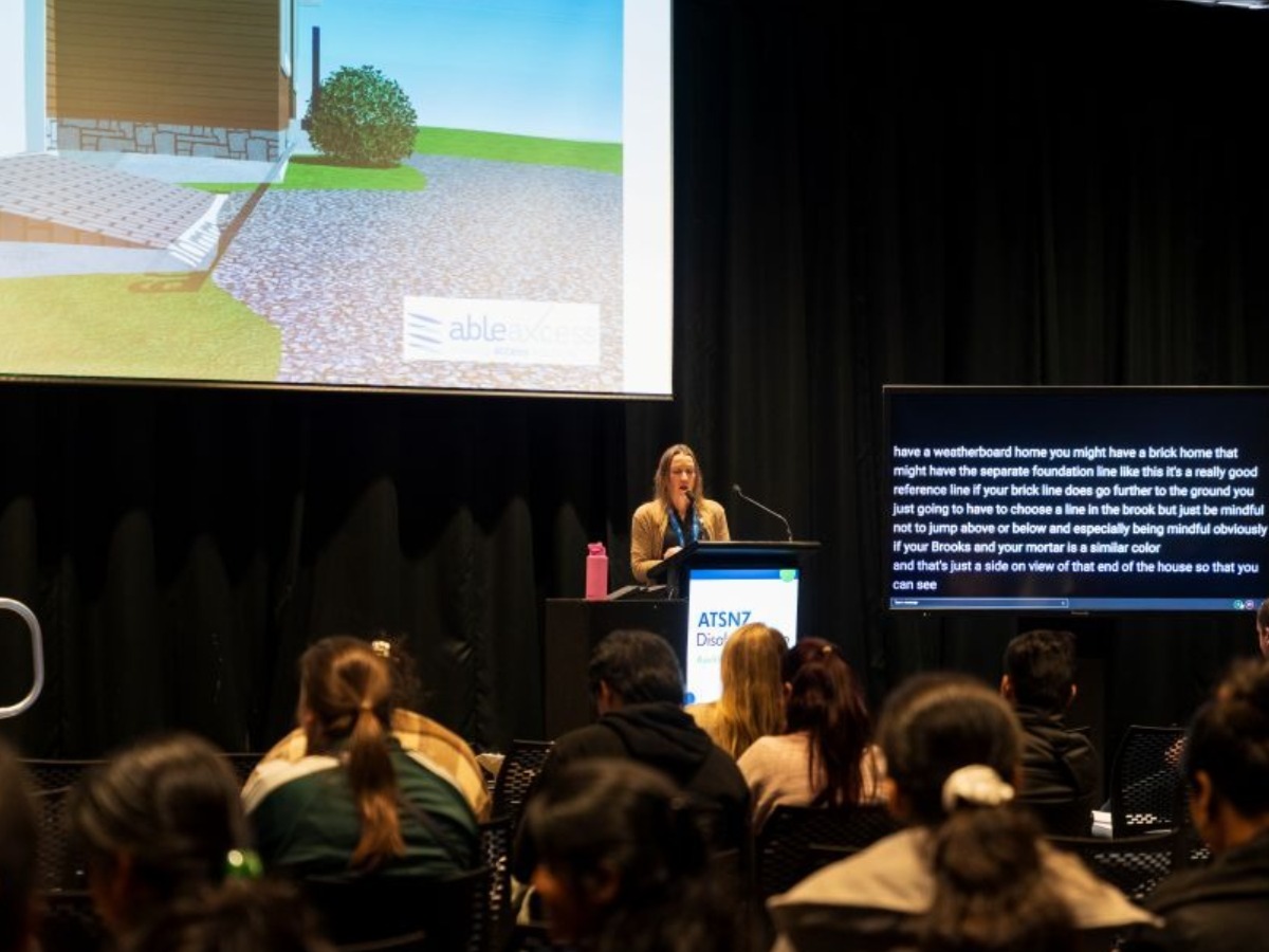Attendees sitting in theatre style chairs watching a Seminar Series Presentation