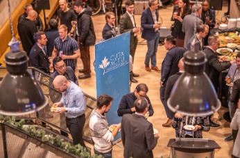 Happy crowd of professionals enjoy conversations at a CUTA event