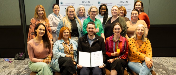 Group of 15 people gathered for a photo with an award.