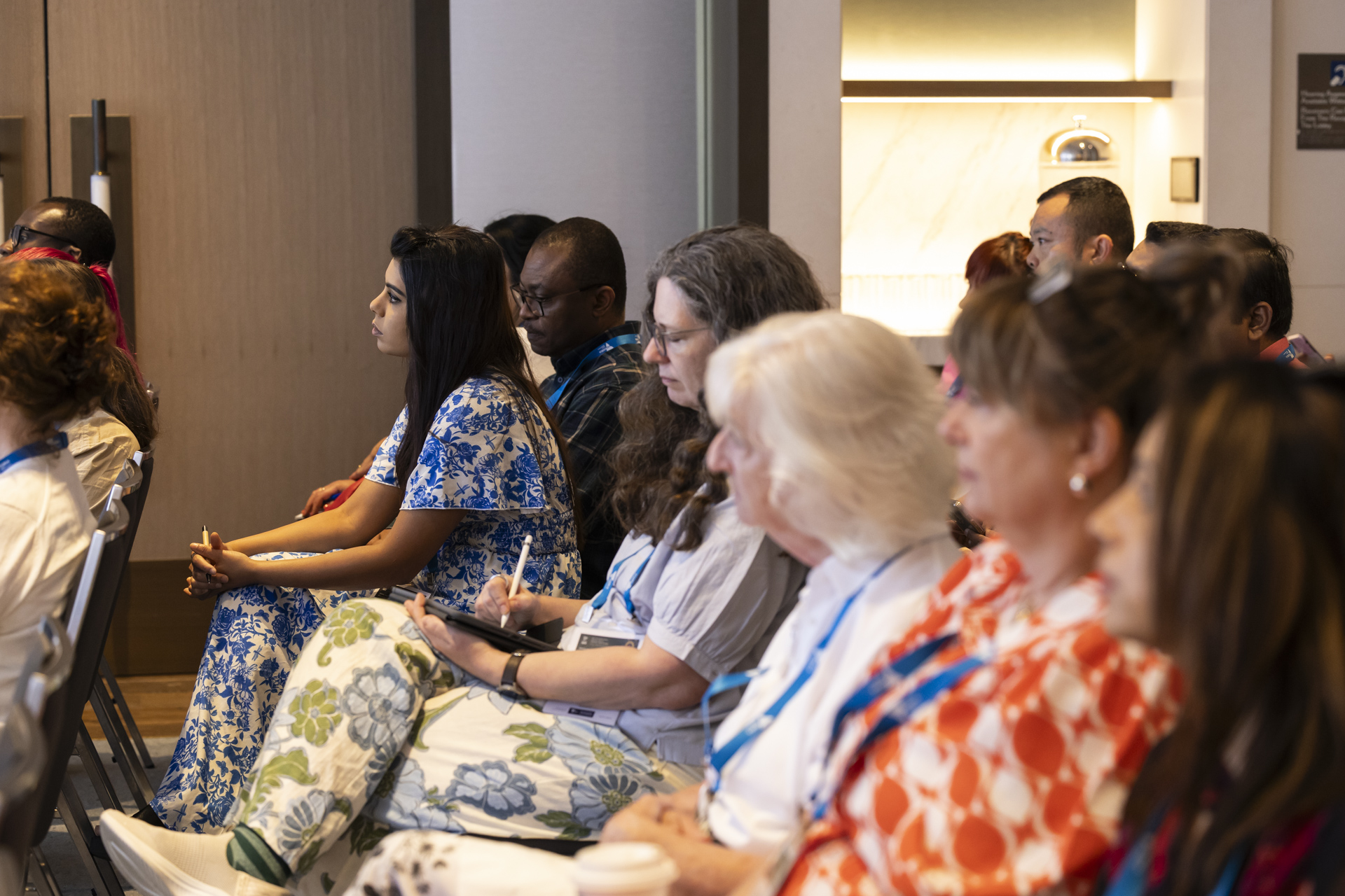 A row of conference delegates listening attentively.