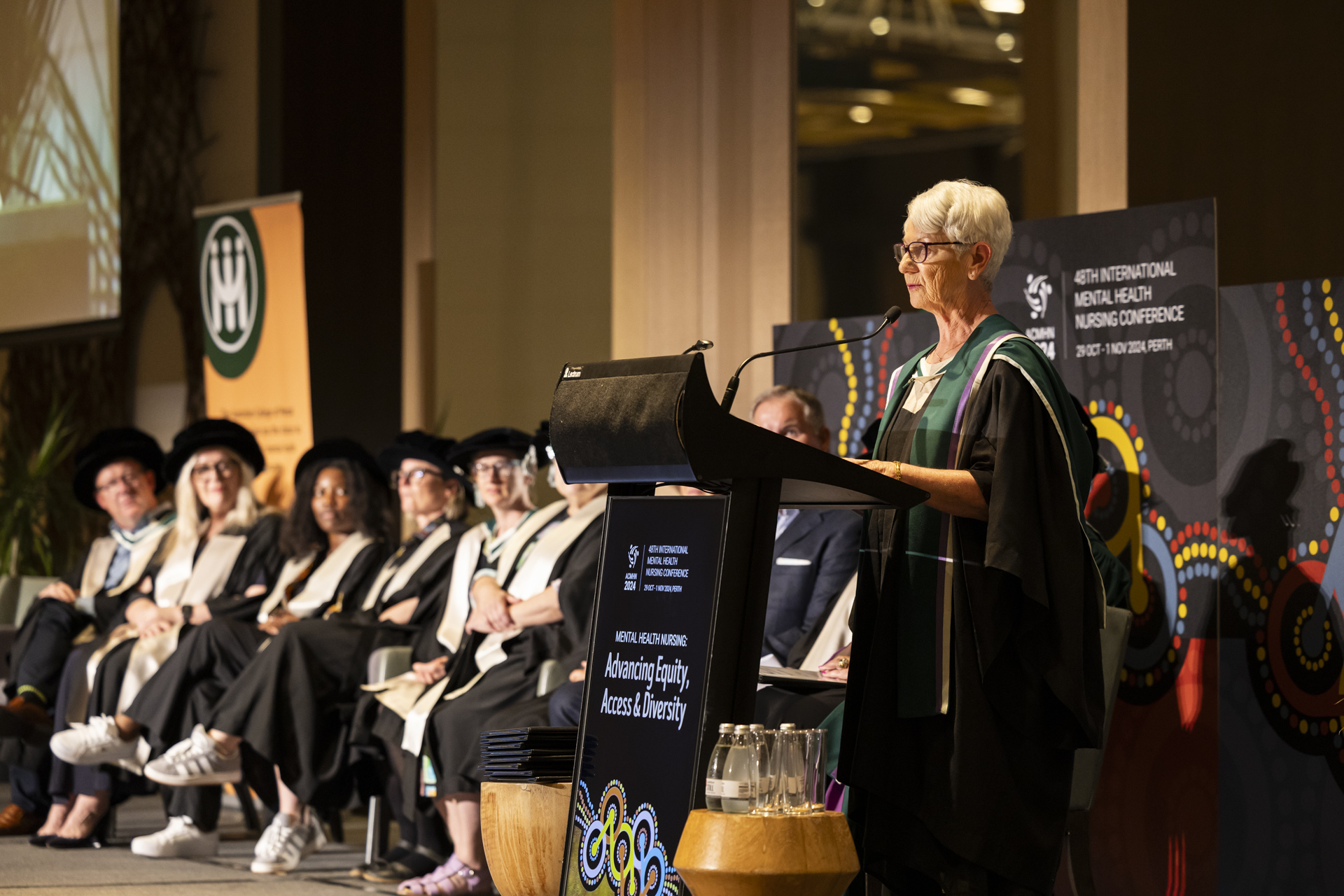 Speaker talking at a podium during the 30th Oration and Investiture Ceremony.