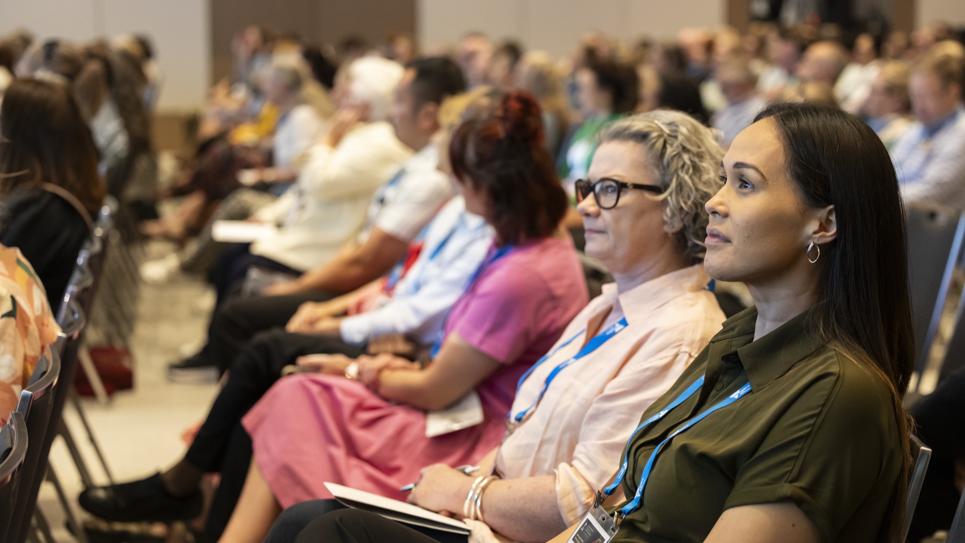 Conference delegates listening attentively to a speaker.