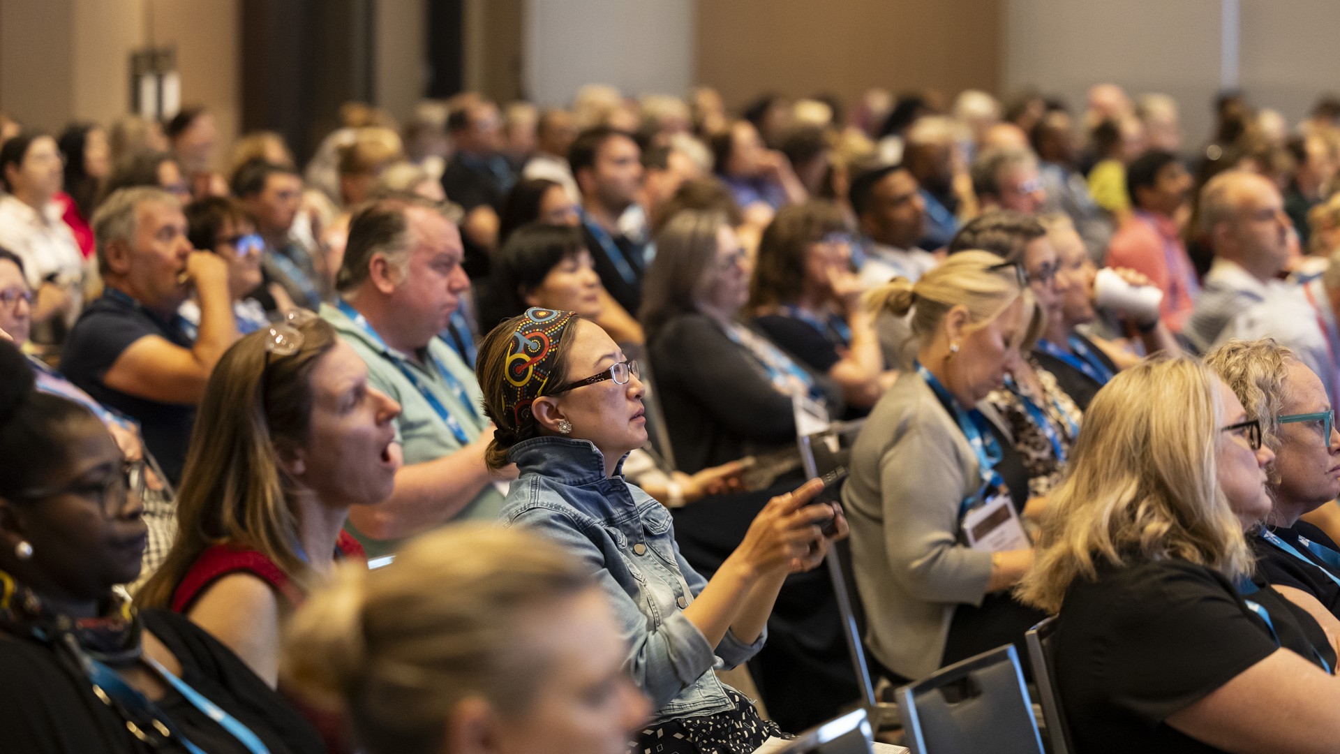 Conference delegates listening attentively to a speaker.