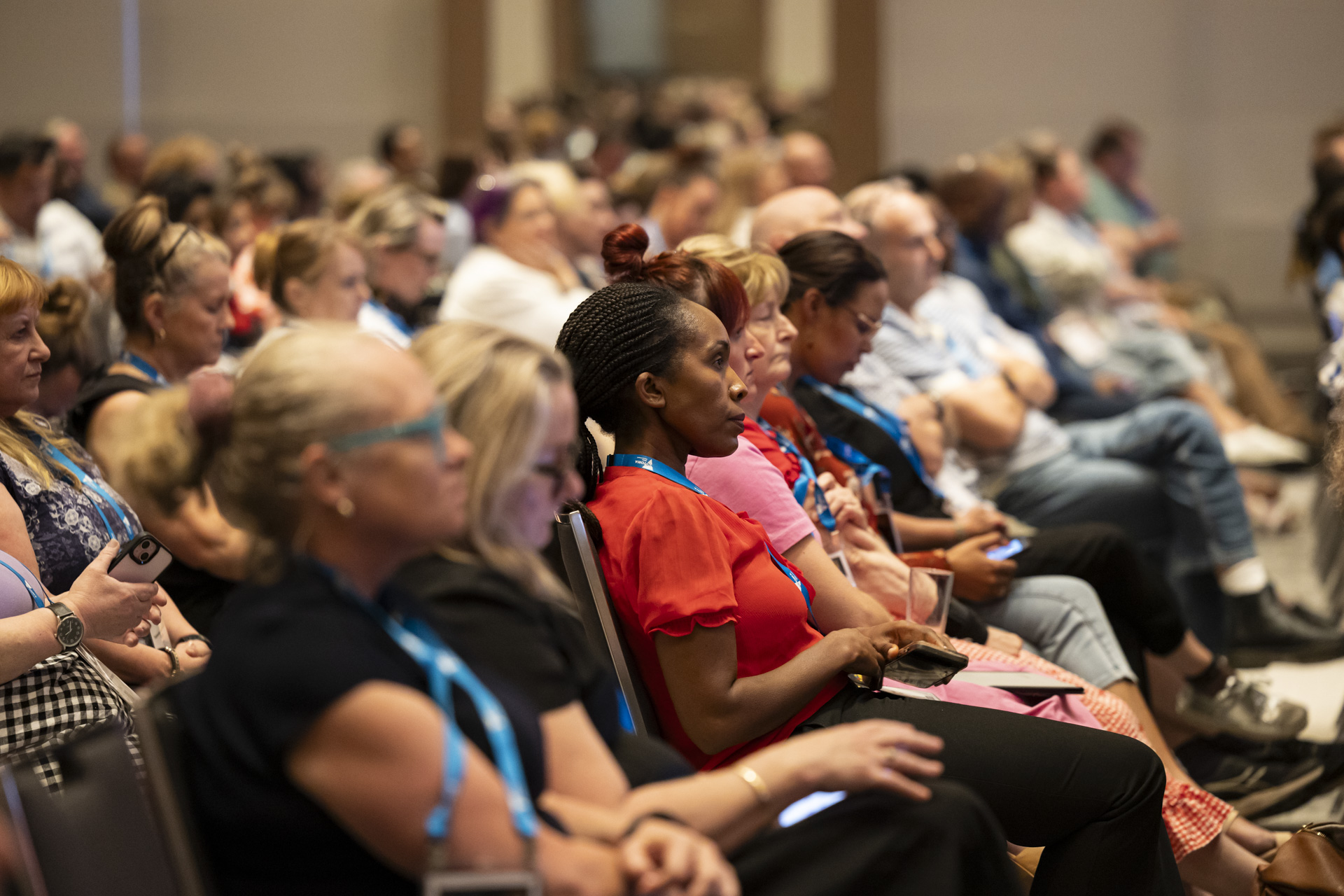 A row of conference delegates listening attentively.