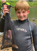 A child holding a net  Description automatically generated