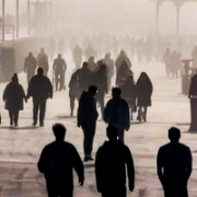 In this image is a street of people walking into smog, depicting the need for societal change